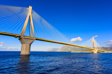 Fototapeta na wymiar The Rion-Antirion Bridge connects the Peloponnese Peninsula with mainland Greece, this Cable-stayed road bridge with pedestrian sidewalks over the Gulf of Corinth, Greece