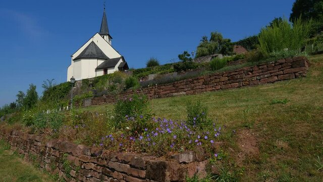 Garden and old Church of Saint Denis, Igel on the Moselle River near Trier, Rhineland-Palatinate, Germany