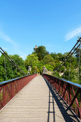 Footbridge in the Parc Buttes-Chaumont with Sibyl Temple in the background - Paris, France