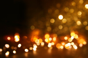 background of abstract gold and black glitter lights. defocused