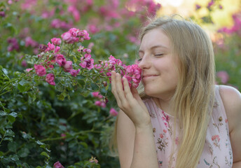 Eine junge Frau riecht Blumen 
