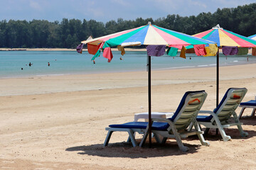 Sea sandy beach with empty sunbeds and umbrellas, selective focus. Vacation on summer resort during coronavirus pandemic