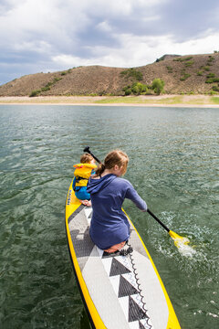 teenage girl and her younger brother on stand up paddle board, Blue Mesa Lake, Crested Butte, CO.