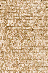 The background of the old beige brick wall for design interior and  various scenes or as a background for video interviews.