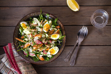 Smocked mackerel fish salad with eggs, arugula and vegetables. Overhead horizontal photo