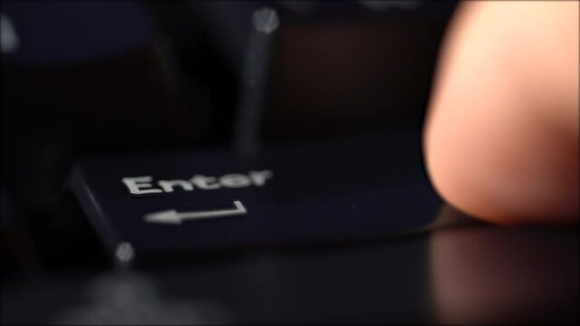 Macro view of Human finger pressing a Backspace key on the computer keyboard