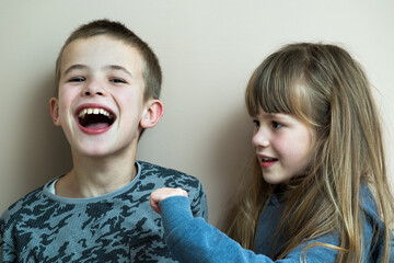 Two children boy and girl fooling around having fun together. Happy childhood concept.