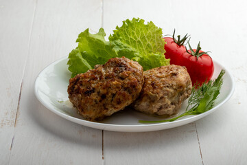 meatballs with tomatoes and lettuce on white background