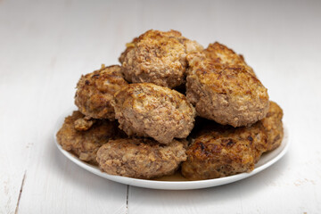 meatballs on a plate on a wooden background