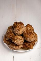 meatballs on a plate on a wooden background