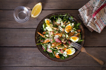 Smocked mackerel fish salad with eggs, arugula and vegetables. Overhead horizontal photo
