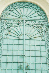 The metal gates are turquoise.With round rings handles. Metallic decorative forging.
