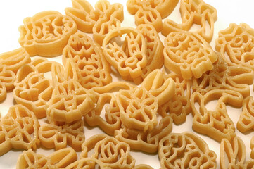 pasta for children Italian dry raw shape of cartoons bronze drawn on white background  top view