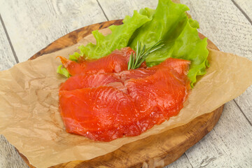 Sliced salmon fillet served rosemary
