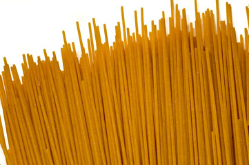 wholemeal spaghetti Italian dry raw pasta  bronze drawn white background top view