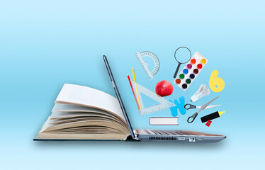 Open book with laptop and educations objects on the blue background