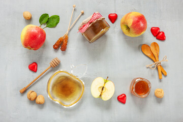 Apples, walnuts, and honey. Concept for Rosh Hashanah the Jewish New Year. Top view, close up on light gray background.