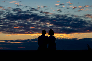 Fototapeta na wymiar couple on the background of the dawn sky