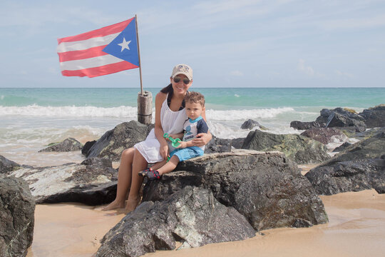 young woman and boy on the beach in Puerto rico with a Puerto rican flag Stock photo Royalty free
