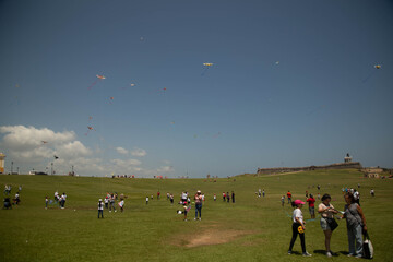 Obraz na płótnie Canvas people flying a kite at El Castillo San Felipe del Morro in San Juan, Puerto Rico sock photo stock photo royalty free 