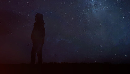 Silhouette of a woman in the night starry sky