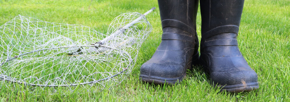 Black Gumboots And Landing Net