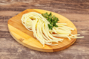 Chechil spaghetti cheese over board