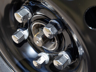 closeup details of automobile wheel lug nut - obrazy, fototapety, plakaty