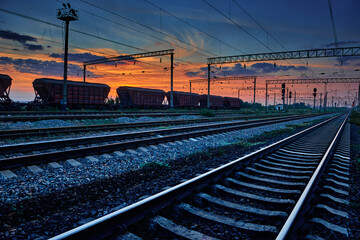 railway and rail cars in a beautiful sunset, dramatic sky and sunlight
