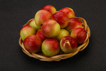 Sweet small nectarines in the basket