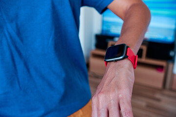 woman arm using smartwatch to control activity indoor