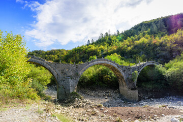 Fototapeta na wymiar Plakida-Kalogeriko bridge. It is a three-stringer bridge that was built in 1814. It is one of the few three-stringer bridges that exist.