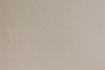 Obraz premium Beige textured wall detail for background. Natural color, rough surface. Flat lay, top view.