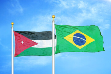 Jordan and Brazil  two flags on flagpoles and blue cloudy sky