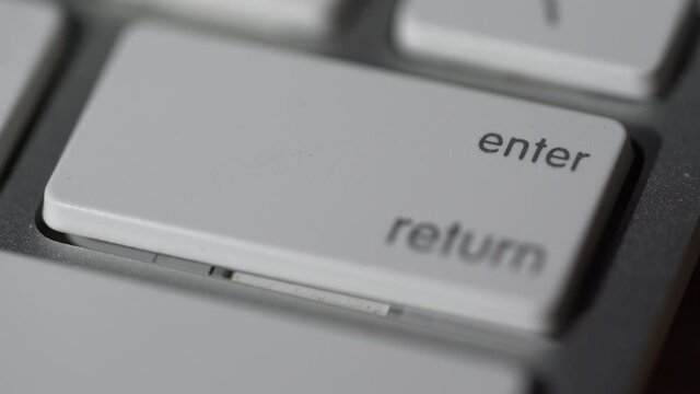 Macro view of Human finger pressing a Backspace key on the computer keyboard