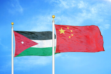 Jordan and China two flags on flagpoles and blue cloudy sky