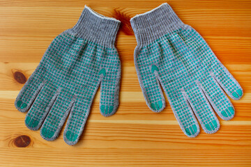 Renovation concept: a pair of work gloves on a wooden table. Flat lay