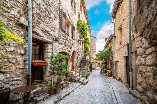 Fototapeta A picturesque back street of homes and apartments in the medieval village of Tourrettes Sur Loup in the Alpes_Maritimes area of Southern France.