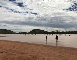people walking on secluded desert beach