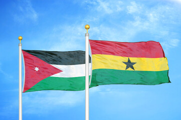 Jordan and Ghana two flags on flagpoles and blue cloudy sky