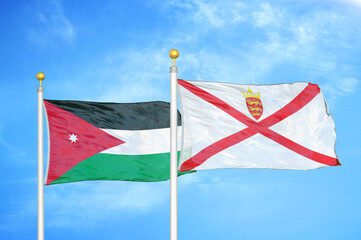 Jordan and Jersey two flags on flagpoles and blue cloudy sky
