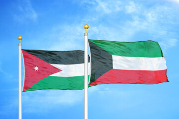 Jordan and Kuwait two flags on flagpoles and blue cloudy sky