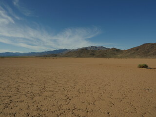Fototapeta na wymiar A harsh barren desert with distant mountains