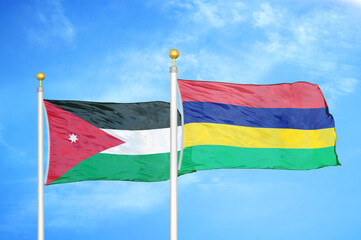 Jordan and Mauritius two flags on flagpoles and blue cloudy sky