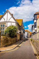 Fototapeta na wymiar A traditional street of individual buildings in the old town of Hastings, Sussex in summer