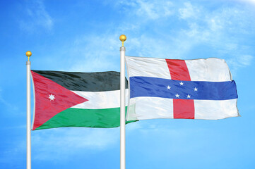Jordan and Netherlands Antilles two flags on flagpoles and blue cloudy sky