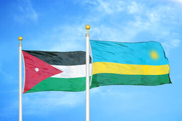 Jordan and Rwanda two flags on flagpoles and blue cloudy sky