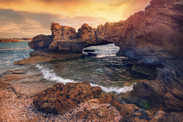 Fototapeta na wymiar Stone arch in the stunning lagoon of Nahsholim Beach, Haifa area of Northern Israel.