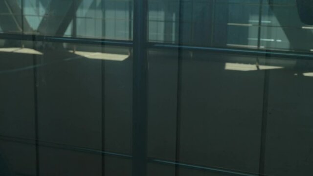 Legs of metro commuters walking in bridge. view through the window.