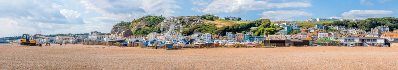 A panorama view across Hastings beach in summer